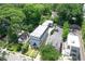 Aerial view of a well-maintained three-story home with manicured lawn and surrounding greenery at 2972 Lookout Ne Pl, Atlanta, GA 30305