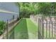 Fenced backyard featuring artificial putting green with lovely stone and wrought iron detail at 2972 Lookout Ne Pl, Atlanta, GA 30305