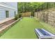 Backyard with a putting green, cornhole, stone wall, and fenced perimeter at 2972 Lookout Ne Pl, Atlanta, GA 30305