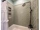 Elegant bathroom tub with decorative tile, bronze fixtures, and shower niche at 2972 Lookout Ne Pl, Atlanta, GA 30305