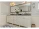 Bright bathroom featuring double vanities, elegant fixtures, and marble countertops at 2972 Lookout Ne Pl, Atlanta, GA 30305