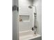 Bathroom featuring subway tile, a niche, and a shower with a tub and curtain at 2972 Lookout Ne Pl, Atlanta, GA 30305