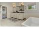 Stylish bathroom with a soaking tub, double vanities, and modern lighting at 2972 Lookout Ne Pl, Atlanta, GA 30305