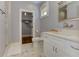 Well-lit bathroom featuring marble floors, a double vanity, and a separate room with an open closet at 2972 Lookout Ne Pl, Atlanta, GA 30305