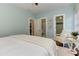 Bedroom with light blue walls, a white armchair, and views to the bathroom and closet at 2972 Lookout Ne Pl, Atlanta, GA 30305