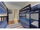 Bedroom showcasing two bunkbeds with hardwood floors and vintage artwork at 2972 Lookout Ne Pl, Atlanta, GA 30305