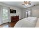 Bedroom features hardwood flooring, light gray walls, and built-in lighting with two large windows at 2972 Lookout Ne Pl, Atlanta, GA 30305