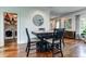 Cozy dining area with a rustic table, black chairs, and laundry in the adjacent room at 2972 Lookout Ne Pl, Atlanta, GA 30305