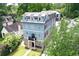 Charming blue three-story home with a metal roof and a small front porch with stone accents at 2972 Lookout Ne Pl, Atlanta, GA 30305