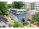 Three-story blue home with a metal roof and a charming front porch balcony at 2972 Lookout Ne Pl, Atlanta, GA 30305