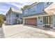 Beautiful blue home showcasing a two-car garage, lovely landscaping, and a welcoming entrance at 2972 Lookout Ne Pl, Atlanta, GA 30305