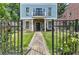 Charming three-story home with blue siding, stone accents, well-manicured front yard and brick walkway at 2972 Lookout Ne Pl, Atlanta, GA 30305