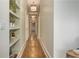 Long hallway with hardwood floors and decorative lighting at 2972 Lookout Ne Pl, Atlanta, GA 30305