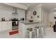 Modern kitchen features an island with bar stool seating, light countertops, and stainless steel appliances at 2972 Lookout Ne Pl, Atlanta, GA 30305