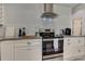 Updated kitchen with modern appliances, stylish backsplash, and granite countertops at 2972 Lookout Ne Pl, Atlanta, GA 30305