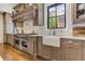 Gourmet kitchen features stainless appliances, a farmhouse sink, and a view to the neighborhood at 2972 Lookout Ne Pl, Atlanta, GA 30305