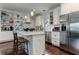 Stylish kitchen with stainless steel appliances, marble countertops, and open shelving at 2972 Lookout Ne Pl, Atlanta, GA 30305