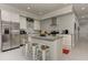 Modern kitchen with stainless steel appliances, island with seating, and bright lighting at 2972 Lookout Ne Pl, Atlanta, GA 30305