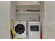 Laundry area features a side-by-side washer and dryer with upper shelving for storage at 2972 Lookout Ne Pl, Atlanta, GA 30305