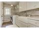 Bright laundry room with modern washer/dryer and farmhouse sink at 2972 Lookout Ne Pl, Atlanta, GA 30305