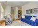 Bright living room featuring a blue sofa, stylish armchair, and built-in shelving at 2972 Lookout Ne Pl, Atlanta, GA 30305