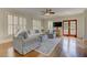 Bright living room with plush seating, ceiling fan, hardwood floors and doors leading to the outside at 2972 Lookout Ne Pl, Atlanta, GA 30305