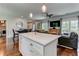 Open-concept living area featuring a kitchen island, dining area, and comfortable seating at 2972 Lookout Ne Pl, Atlanta, GA 30305