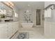 Modern main bathroom featuring a soaking tub, a glass-enclosed shower, and marble flooring at 2972 Lookout Ne Pl, Atlanta, GA 30305
