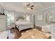 Bright main bedroom features hardwood floors, ceiling fan, and a large window with natural light at 2972 Lookout Ne Pl, Atlanta, GA 30305