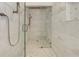 Spacious shower featuring a bench and marble tiles at 2972 Lookout Ne Pl, Atlanta, GA 30305