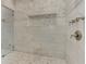 Close-up of the shower showcasing elegant marble tiling and recessed shelf at 2972 Lookout Ne Pl, Atlanta, GA 30305
