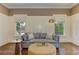 Sitting area featuring a gray sofa, decorative pillows, and natural lighting at 2972 Lookout Ne Pl, Atlanta, GA 30305