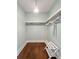A tidy walk-in closet with wood floors and built-in shelving, ready for organization at 2972 Lookout Ne Pl, Atlanta, GA 30305