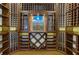 Custom designed wine cellar with extensive shelving and artistic Tuscan-themed backdrop at 2972 Lookout Ne Pl, Atlanta, GA 30305