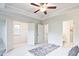 Bright main bedroom with coffered ceilings, an en suite bath and a walk-in closet at 541 Fundao Ln, Lawrenceville, GA 30046