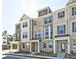 Modern townhome showcases a brick facade, large windows, and covered front entry at 541 Fundao Ln, Lawrenceville, GA 30046