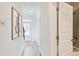 Bright hallway with wood-look floors, modern decor, and a view of the front door and an open bathroom at 541 Fundao Ln, Lawrenceville, GA 30046