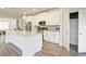 Modern kitchen boasts an island, white cabinets, stainless appliances, and a walk-in pantry at 541 Fundao Ln, Lawrenceville, GA 30046