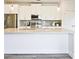 A well-equipped kitchen featuring a large island with a granite countertop, white cabinets, and stainless steel appliances at 541 Fundao Ln, Lawrenceville, GA 30046