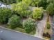 Aerial view of a home with mature trees, landscaping, and a winding driveway at 6203 Crestview Drive Southeast Se Dr, Covington, GA 30014