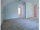 Finished attic with neutral carpeting and multiple access doors at 6203 Crestview Drive Southeast Se Dr, Covington, GA 30014