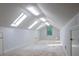 Finished attic with skylights, window, and neutral carpeting at 6203 Crestview Drive Southeast Se Dr, Covington, GA 30014