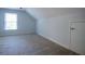 Finished attic with window and neutral carpeting at 6203 Crestview Drive Southeast Se Dr, Covington, GA 30014