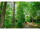 Secluded backyard featuring a cozy seating area surrounded by mature trees and landscaping at 6203 Crestview Drive Southeast Se Dr, Covington, GA 30014
