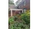Brick home exterior with a pergola, manicured landscaping, and a serene garden area at 6203 Crestview Drive Southeast Se Dr, Covington, GA 30014
