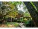 Beautiful backyard featuring a brick home, mature trees, and well-manicured landscaping at 6203 Crestview Drive Southeast Se Dr, Covington, GA 30014
