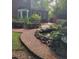 Backyard with a brick walkway, garden, pond, and foliage at 6203 Crestview Drive Southeast Se Dr, Covington, GA 30014