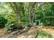 Landscaped backyard with a charming pond and a white picket fence at 6203 Crestview Drive Southeast Se Dr, Covington, GA 30014