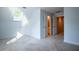 Bedroom featuring an attic window, neutral carpet, white walls, and doors to other rooms at 6203 Crestview Drive Southeast Se Dr, Covington, GA 30014