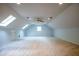 Spacious bonus room featuring vaulted ceilings, skylights, a ceiling fan, and neutral carpeting at 6203 Crestview Drive Southeast Se Dr, Covington, GA 30014